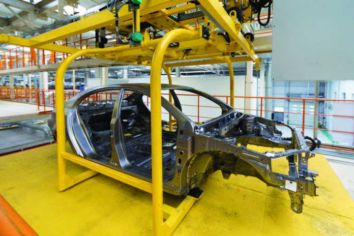 body of car on conveyor Modern Assembly of cars at plant. automated build process of the car body
